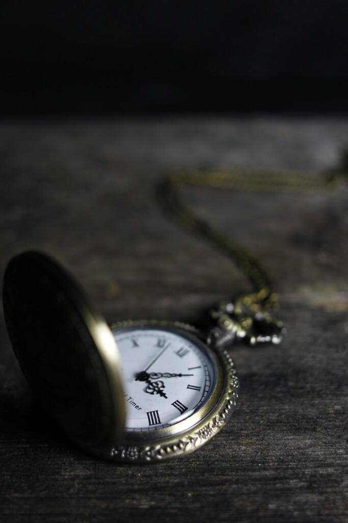 pexels-photo-277290-277290 Close-up of an ornate vintage pocket watch on a wooden surface, exemplifying timeless elegance.
