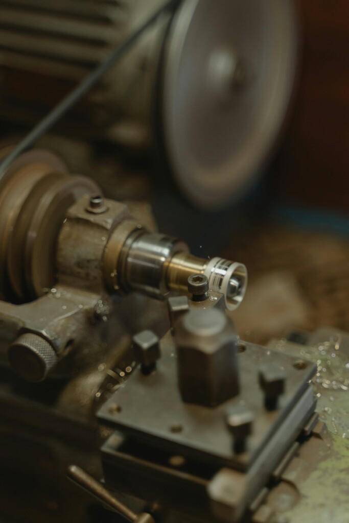 pexels-photo-6263103-6263103 Detailed view of a metal lathe working in an industrial workshop environment.