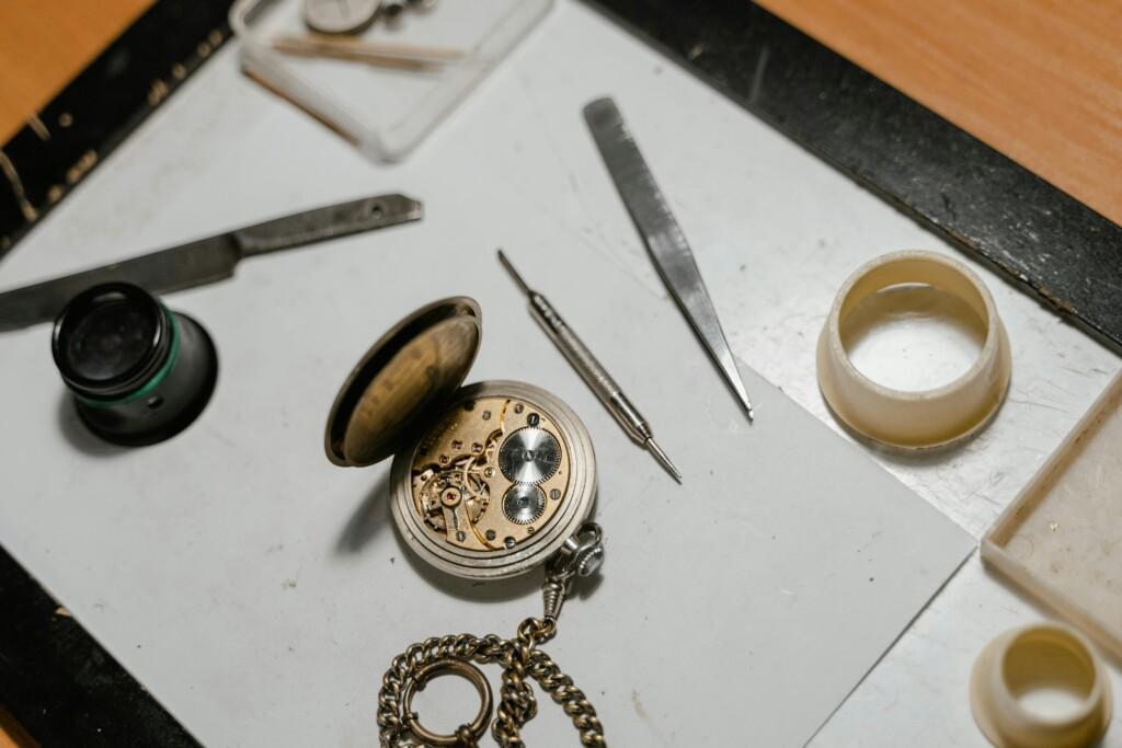 pexels-photo-8327596-8327596 Detailed view of a vintage pocket watch with repair tools, showcasing precision craftsmanship.