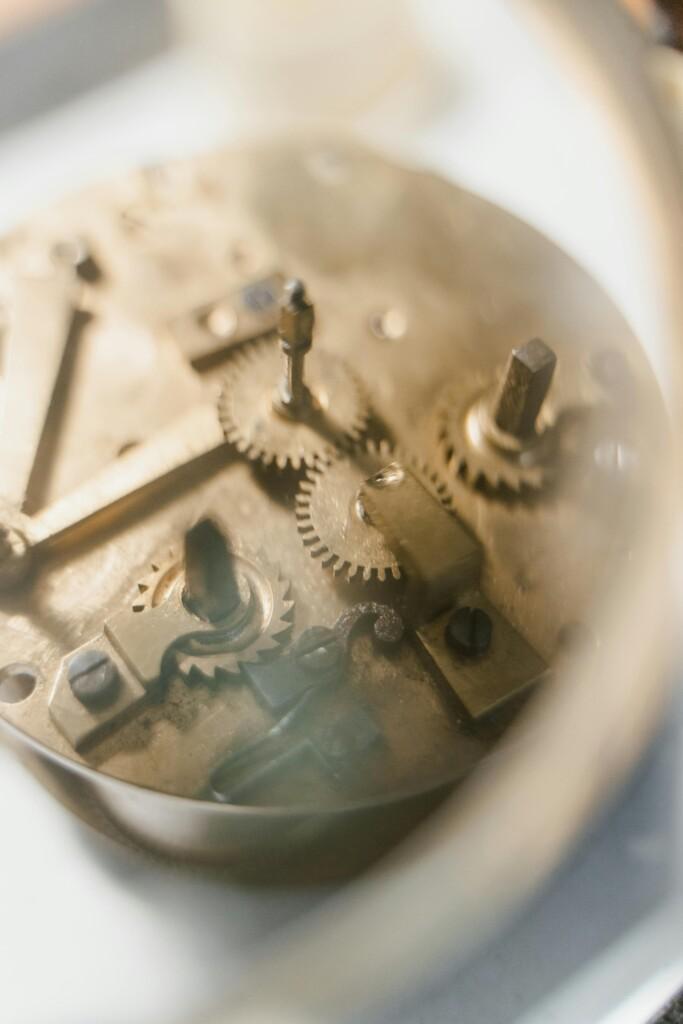 pexels-photo-8327817-8327817 Detailed view of clock mechanism showcasing gears and components.
