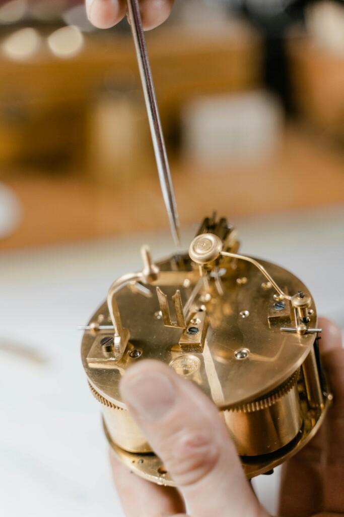 pexels-photo-8327882-8327882 Detailed close-up of delicate clock repair process, showcasing craftsmanship and precision.